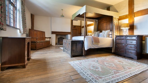 One of the double bedrooms with a four poster bed at Cwmmau Farmhouse, Herefordshire